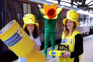 L to R Natalie Atherley from Marie Curie’s fundraising team and Becky Daniels from Northern Rail celebrate the partnership with Daffy, the Marie Curie mascot