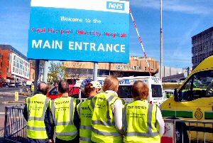 Ninette Thomas and her family display the customised high-vis vests they wore for the 150-mile walk from Holyhead to the Royal Liverpool University Hospital.