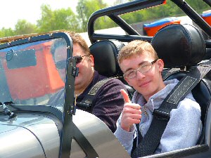 Volunteer Tim Pollard takes visually impaired Thomas Sweeney, 15, for a spin in his Caterham Galloways Society for the Blind gave 50 thrill-seeking blind and partially sighted people from Lancashire and Sefton the chance to take to the wheel and drive around a race track recently at Three Sisters Race Circuit, Wigan.