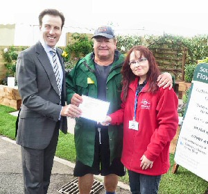 Galloways Society receiving silver Gilt award from Alan Francis.