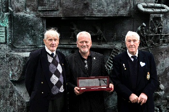 The oldest surviving D-Day brother, Johnny Dale. In the centre is his brother Ernest Dale. Presenting the award is Nick Mottershead, representing the Lest We Forget Charity Association and The Bradford Exchange. 