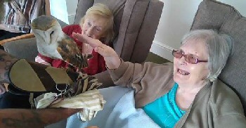 Residents Louisa Delacruz (L) and Ellen Sayonas (R) get friendly with the beautiful birds.