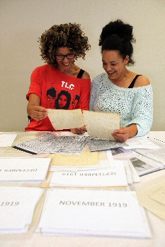 Photo 1 – Sharon Lane and Janaya Pickett look at the archive.