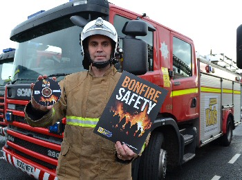 Watch Manager Ian Mullen with the Bonfire Safety pack, containing the bonfire DVD that is being shown at schools across Merseyside. Photo by Merseyside Fire & Rescue Service.