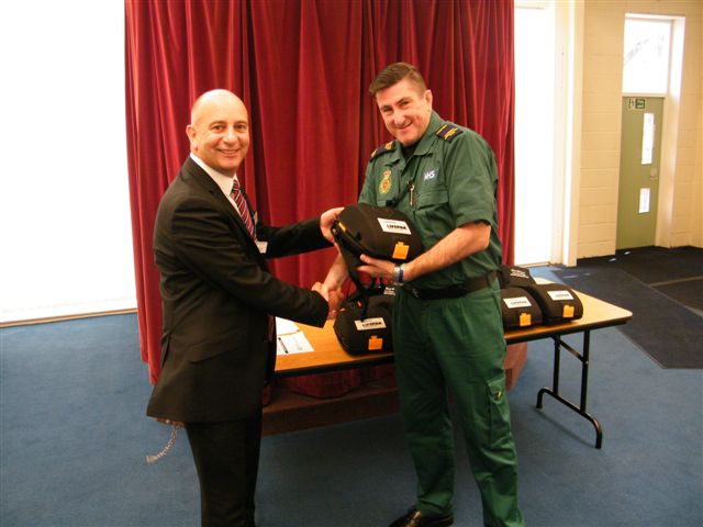HMP Kennet Deputy Governor Robbie Durgan receiving the defibrillators from NWAS Community Resuscitation Development Officer Rob Sharples.