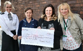 Macmillan nurses meet at Merseyside Police headquarters to receive a cheque from Kelly Coulton (centre), PC Martin Duddy (centre), Ch Supt Claire Richards (left) and Chief Inspector Simon Thompson (right)