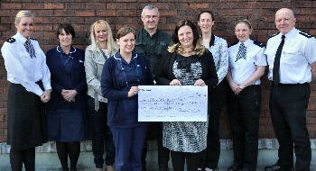 Macmillan nurses meet at Merseyside Police headquarters to receive a cheque from Kelly Coulton (centre), PC Martin Duddy (centre), Ch Supt Claire Richards (left) and Chief Inspector Simon Thompson (right)