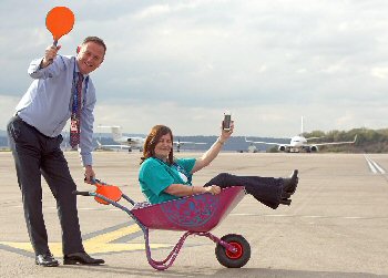 LJLAs CEO Andrew Cornish and HR and Community Director Carol Dutton already in training for the Airports wheel barrow race that will help raise funds for Alder Heys digital app.