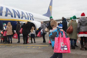 Children from Alder Hey with parents and Airport employees excitedly boarding the special Ryanair flight at LJLA.